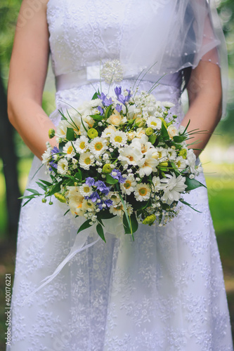 wedding flower bouquet in the hands of the bride