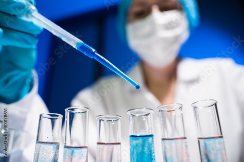Laboratory worker mixes two substances in a test tube