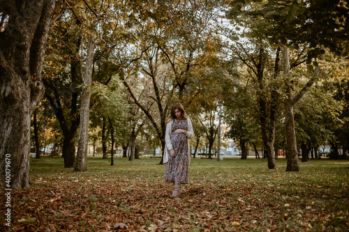 Beautiful pregnant woman walking in the park © Gardinovacki