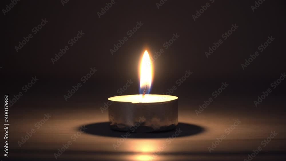 Single spiritual candle blown on dark background Single spiritual candle blown on dark background