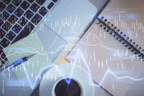 Stock market graph and top view computer on the table background. Double exposure. Concept of financial education.