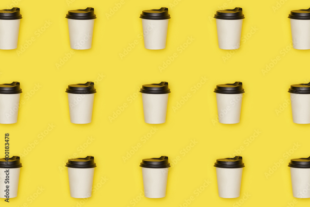 Flat lay paper white cup with back plastic cover pattern on yellow illuminating background. High quality photo Flat lay paper white cup with back plastic cover pattern on yellow illuminating background. High quality photo