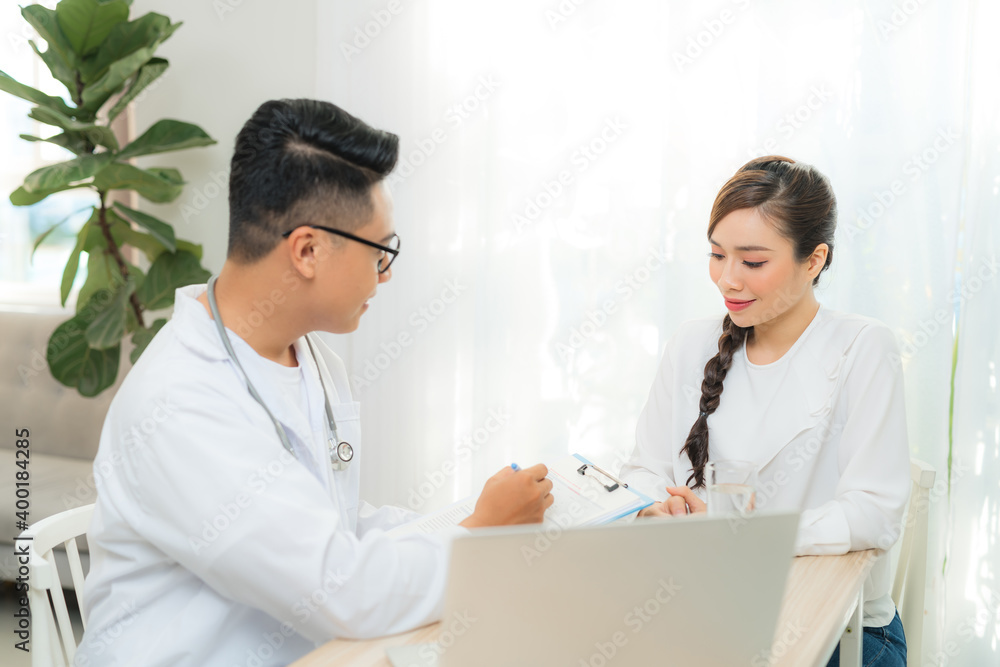 Male Obstetrician-gynecologist working with young stress woman in clinic or hospital healthcare Male Obstetrician-gynecologist working with young stress woman in clinic or hospital healthcare