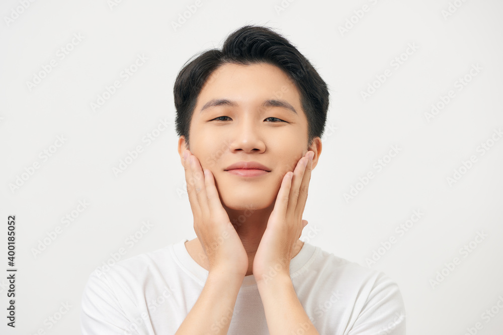 Beauty portrait of half naked handsome young man touching his face isolated over white background Beauty portrait of half naked handsome young man touching his face isolated over white background
