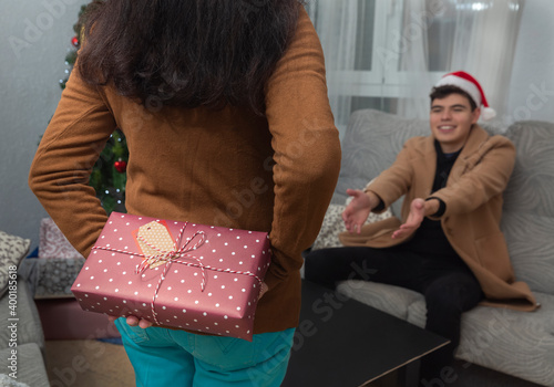 A young man receives a gift from a woman