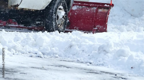 Close up from snow plowing truck in winter slow motion