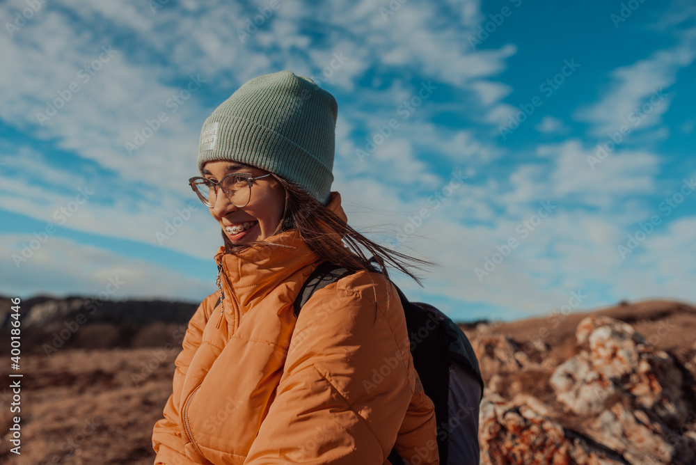 Freedom traveler woman sitting on the top of mountains and enjoy a wonderful nature. Yound girl on peak mountain with perfect view snowy mountains. travel concept