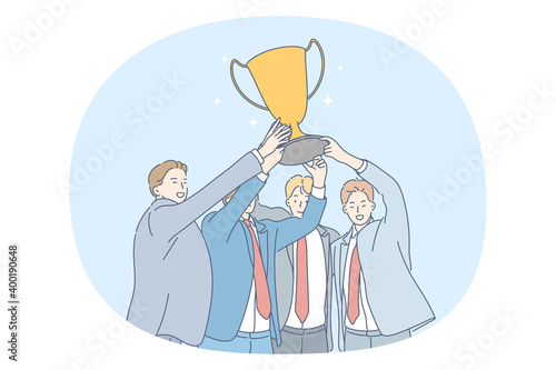 Success, Teamwork, business development concept. Happy young business people partners celebrating successful project realisation and holding golden trophy in hands together. Partnership, cooperation 