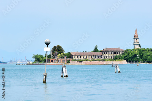Poveglia, a small island located between Venice and Lido in the Venetian Lagoon, Italy, as seen from Malamocco on Lido Island. It was used as a quarantine station in history.