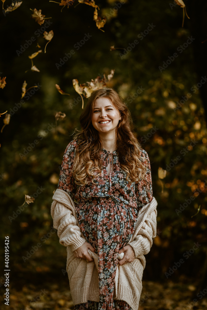 Lovely pregnant woman enjoying autumn in the park Lovely pregnant woman enjoying autumn in the park