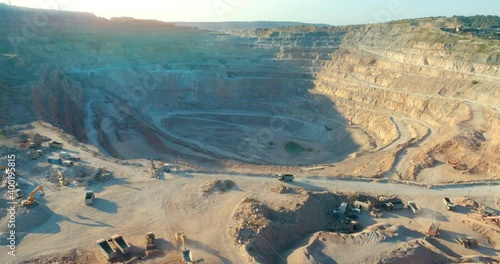 Aerial view of opencast mining quarry with lots of machinery at work - view from above. 