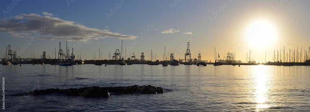Panoramic image of the bay from the shore at sunrise and port in the background, Alcaravaneras beach, Las Palmas of Gran Canaria