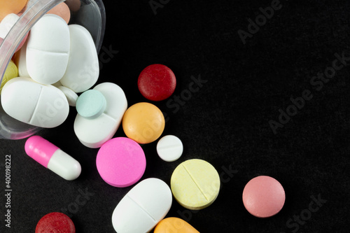 Lot of pharmaceutical pills medicine from above in black background