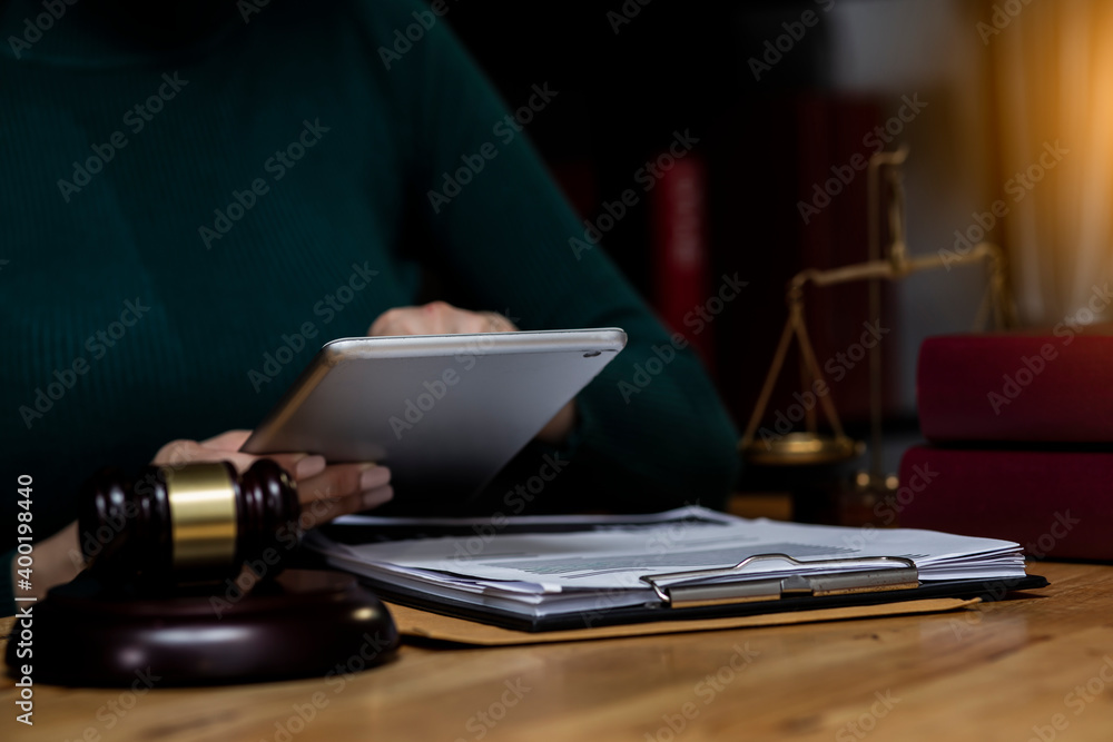 Concepts of Law and Legal services. Lawyer working with digital tablet on table office.