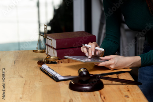 Concepts of Law and Legal services. Lawyer working with digital tablet on table office. © SOMKID