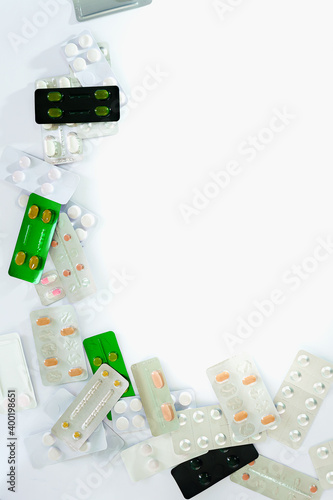 Lot of pharmaceutical pills medicine from above in white background