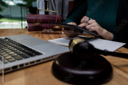 Concepts of Law and Legal services. Lawyer working with digital tablet on table office.