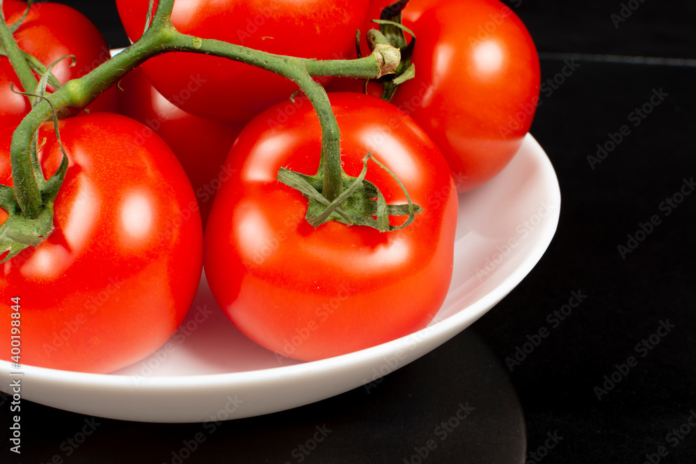 large red tomatoes in a white dish large red tomatoes in a white dish
