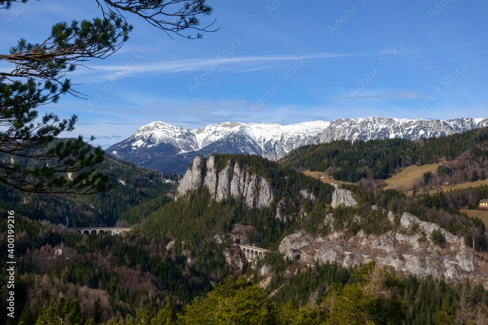 old railroad tunnel in the landscape with high mountain range and snow old railroad tunnel in the landscape with high mountain range and snow