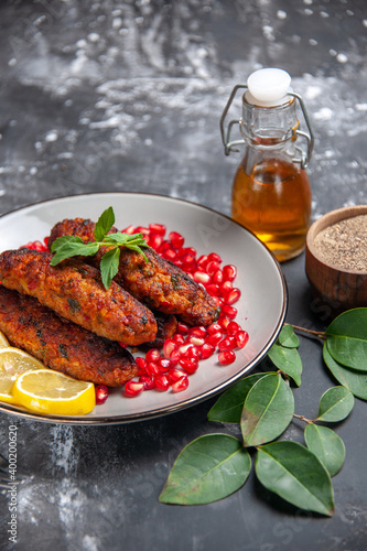 front view long meat cutlets with seasonings on a grey background food dish meal