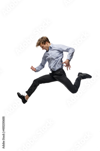 Music. Happy young man dancing in casual clothes or suit, remaking legendary moves and dances of celebrity from culture history. Isolated on white. Action, motion, fame concept. Creative occupation.