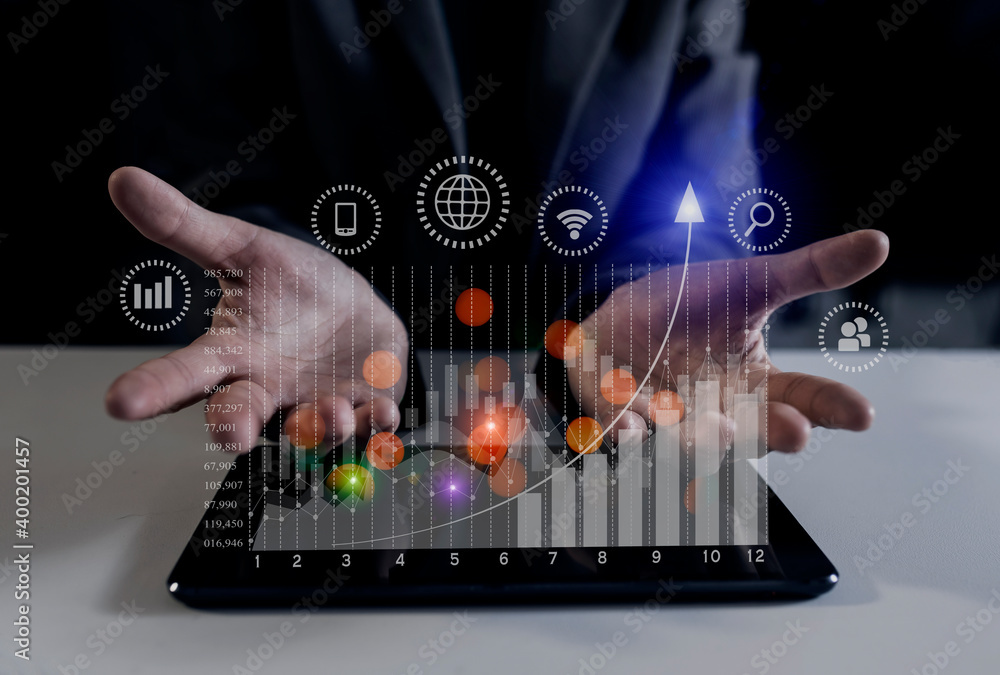 Naklejka premium Double exposure of businesswoman hand touching on tablet with business financial virtual chart, Digital marketing concept. 