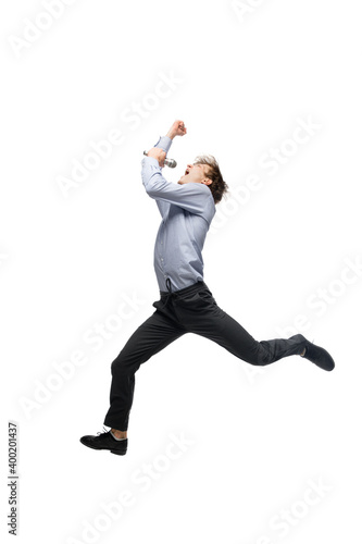 Singer. Happy young man dancing in casual clothes or suit, remaking legendary moves and dances of celebrity from culture history. Isolated on white. Action, motion, fame concept. Creative occupation.