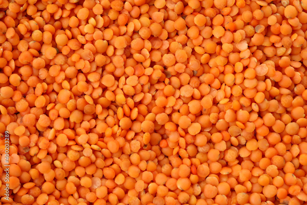 Uncooked red legumes on whole background, top view