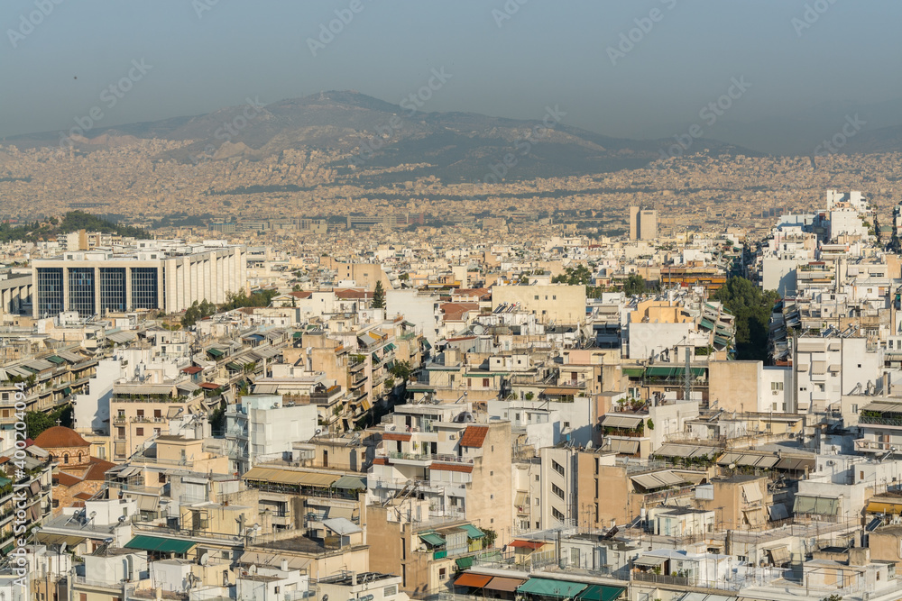 Aerial view of cityscape with high skyline and rooftops of Athens in a sunny day, Greece