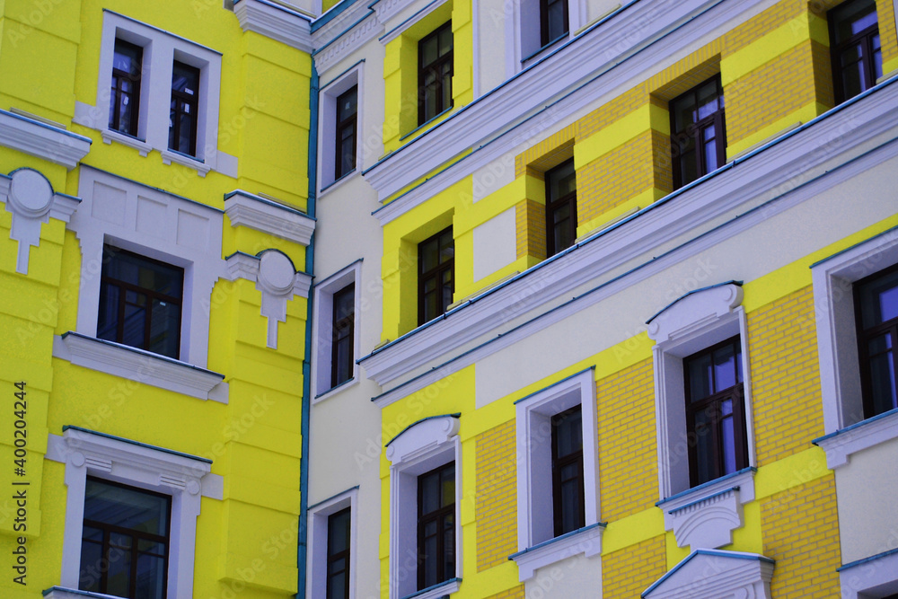 White windows in a bright yellow house