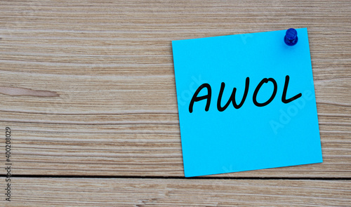 AWOL - acronym written on a blue sheet pinned to a wooden board photo