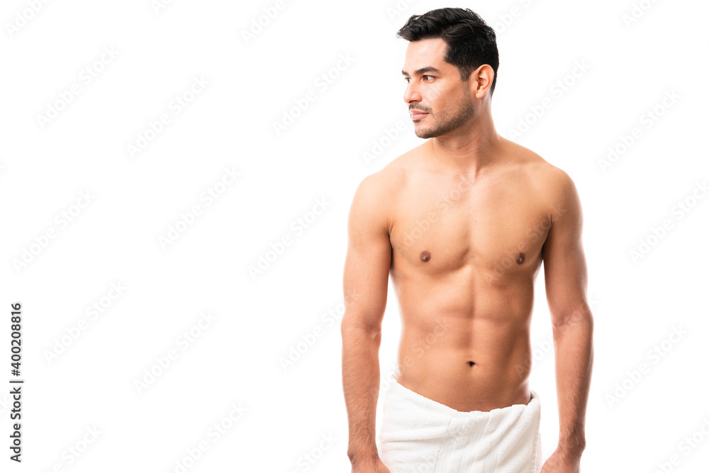 Fototapeta premium Shirtless Hispanic male in towel