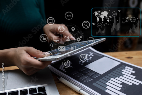 Double exposure of businesswoman hands working on digital tablet and smart digital marketing virtual chart, Abstract icon, Business strategy concept.