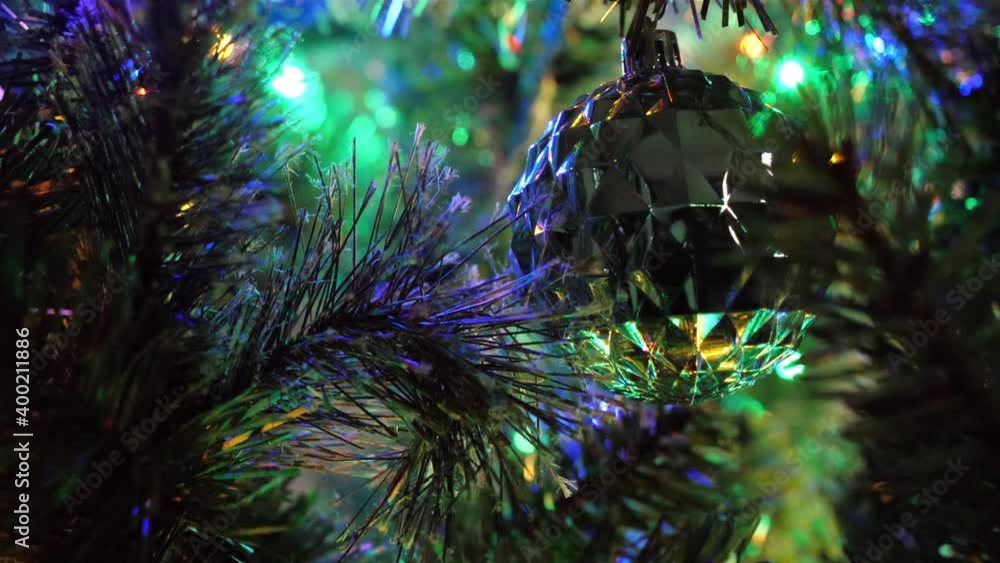Abstract 4k video background of blinking multi-colored lights and ornaments in a Christmas tree