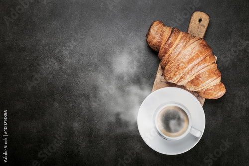 freshly baked croissants and a Cup of coffee on the table