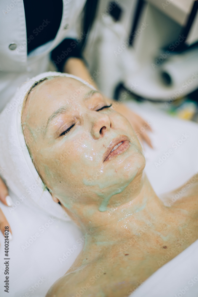 mature woman in beauty clinic getting an anti age facial treatment mature woman in beauty clinic getting an anti age facial treatment