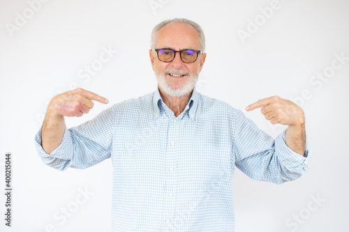 Konstfotografi Senior handsome man wearing casual shirt and glasses over isolated white background looking confident with smile on face, pointing oneself with fingers proud and happy