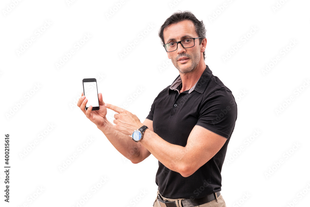 A middle-aged man points to a smartphone. Portrait of an attractive man with glasses. echnology, gadget, advertisement concept