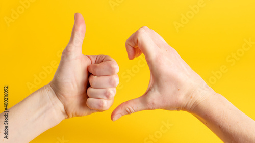 Friendzone hand sign on yellow background. Friend zone symbol. Friendzoned hands shape