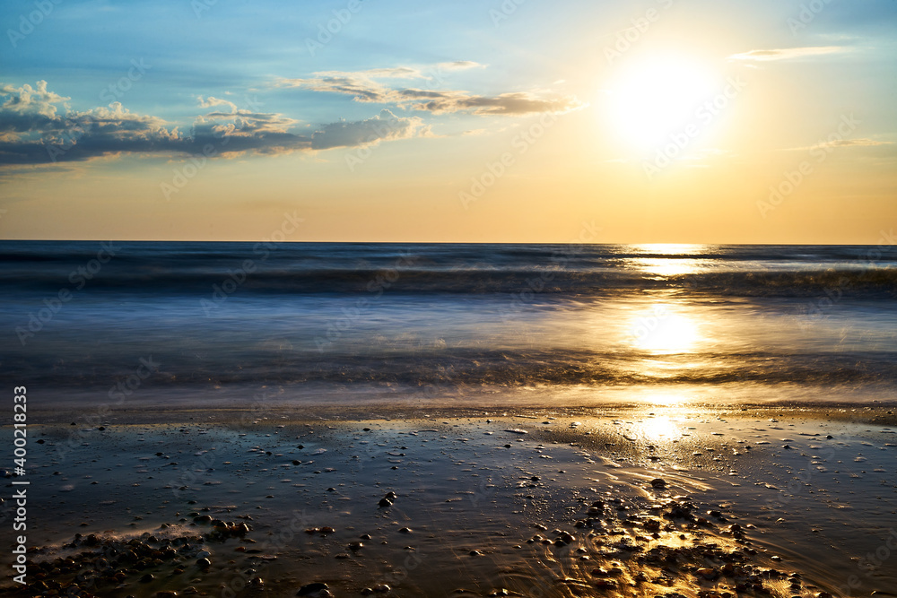 Naklejka premium Sea sunset. Quiet calm sea. Sand beach.