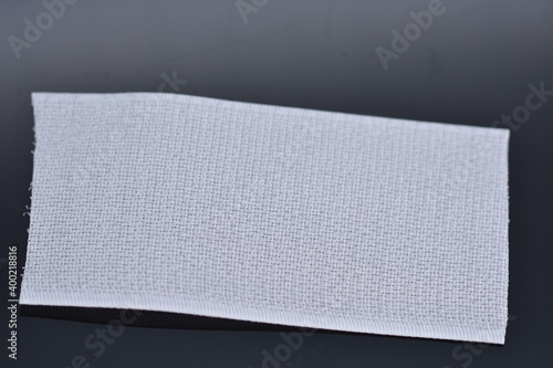Foto white Velcro tape isolated on black