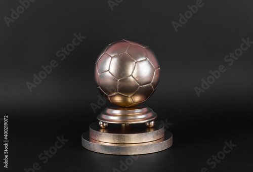 golden soccer ball on golden pedestal