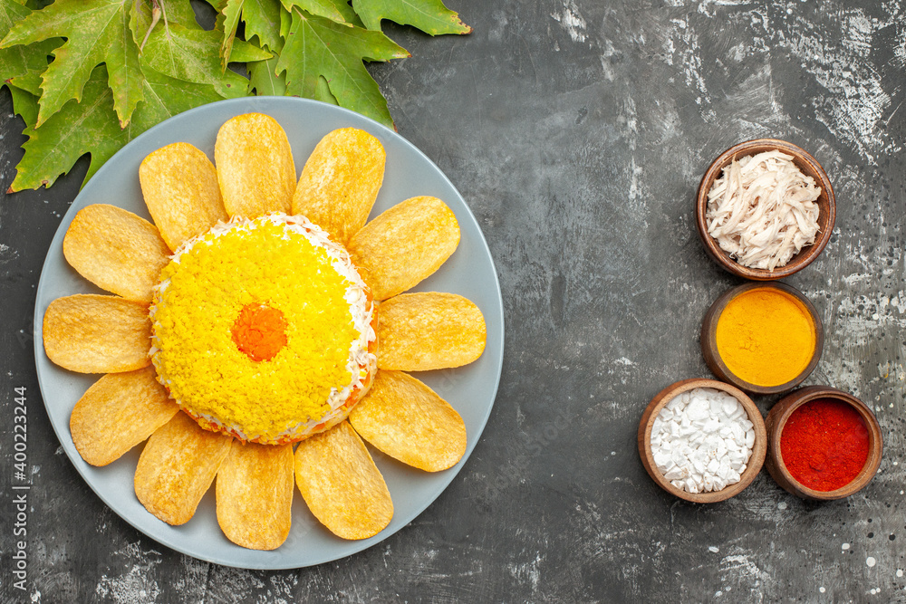 top view of salad with leaves and herbs on dark grey table