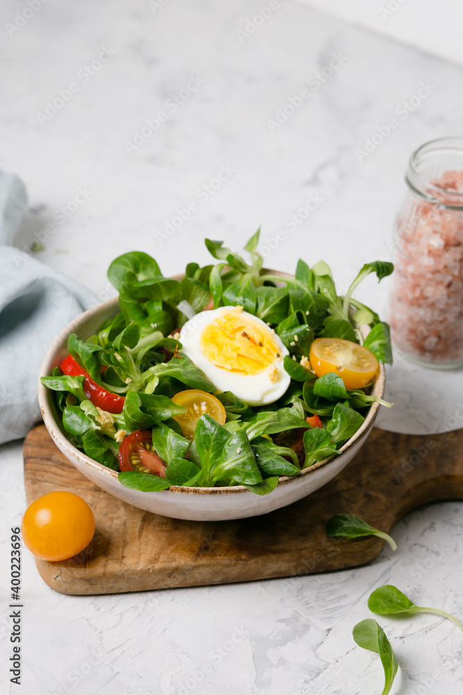Vegetable salad with egg on white background