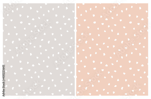 Fototapeta Naklejka Na Ścianę i Meble -  Simple Irregular Geometric Seamless Vector Patterns Set. White Freehand Spots Isolalet on a Light Gray and Light Salmon Pink Background. Abstract Doodle Print ideal for Fabric, Textile,Wrapping Paper.