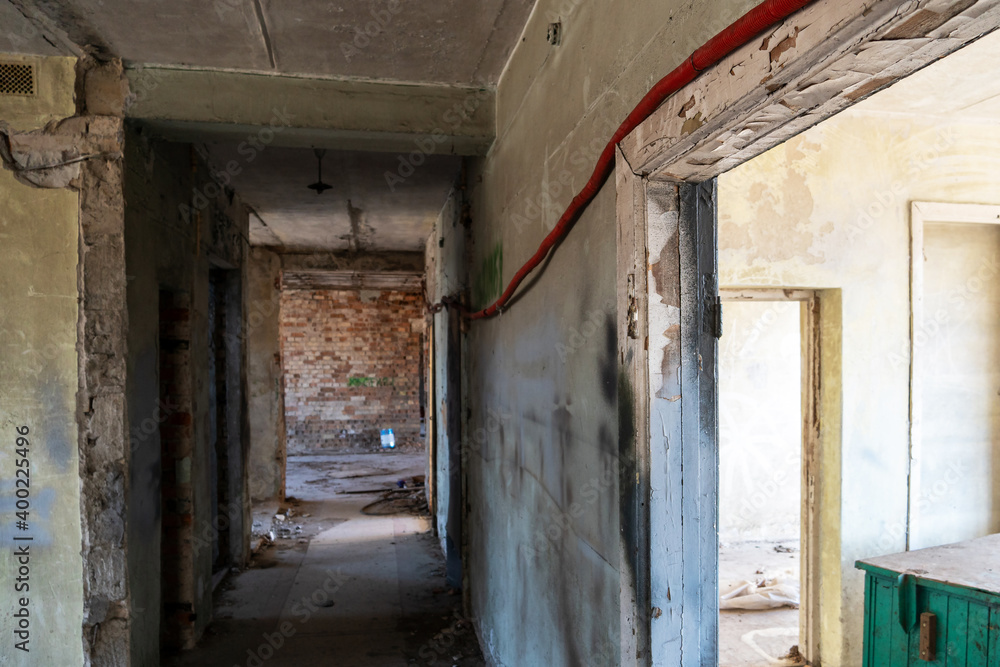 Renovation in the apartment. Destroyed buildings after an earthquake or cataclysm. Walls without plaster and broken red brick. Lack of windows and doors in abandoned apartments.