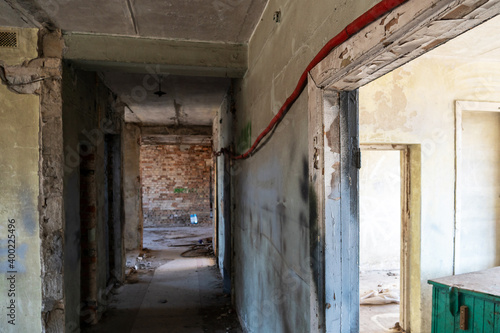 Renovation in the apartment. Destroyed buildings after an earthquake or cataclysm. Walls without plaster and broken red brick. Lack of windows and doors in abandoned apartments.