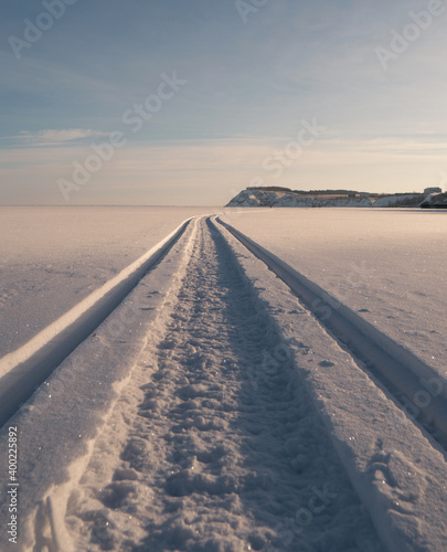 the snowmobile left behind a long strip in the snow