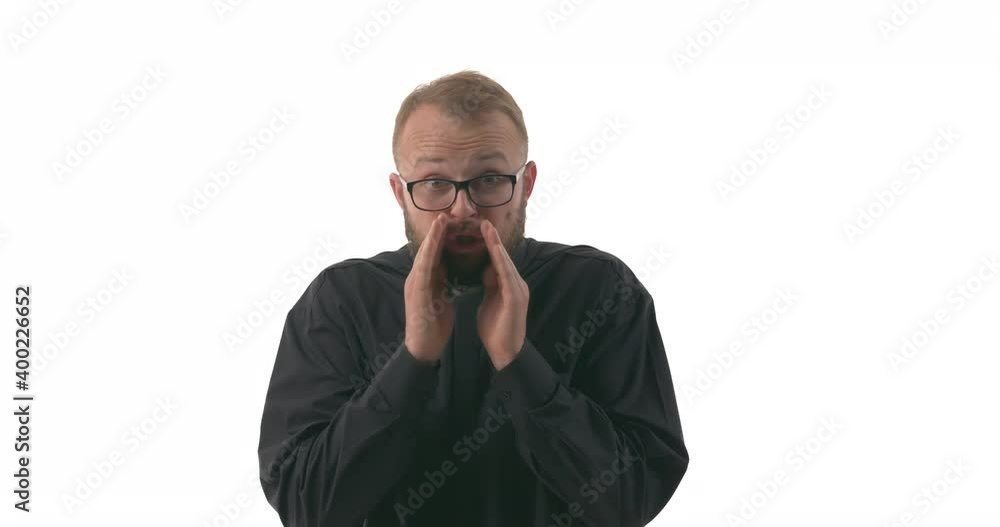 Portrait of young Caucasian priest make cupping gesture. Calling someone with hands around mouth. Private talk. Isolated on white background Portrait of young Caucasian priest make cupping gesture. Calling someone with hands around mouth. Private talk. Isolated on white background