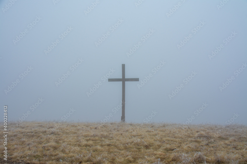 a cross on a field with fog a cross on a field with fog
